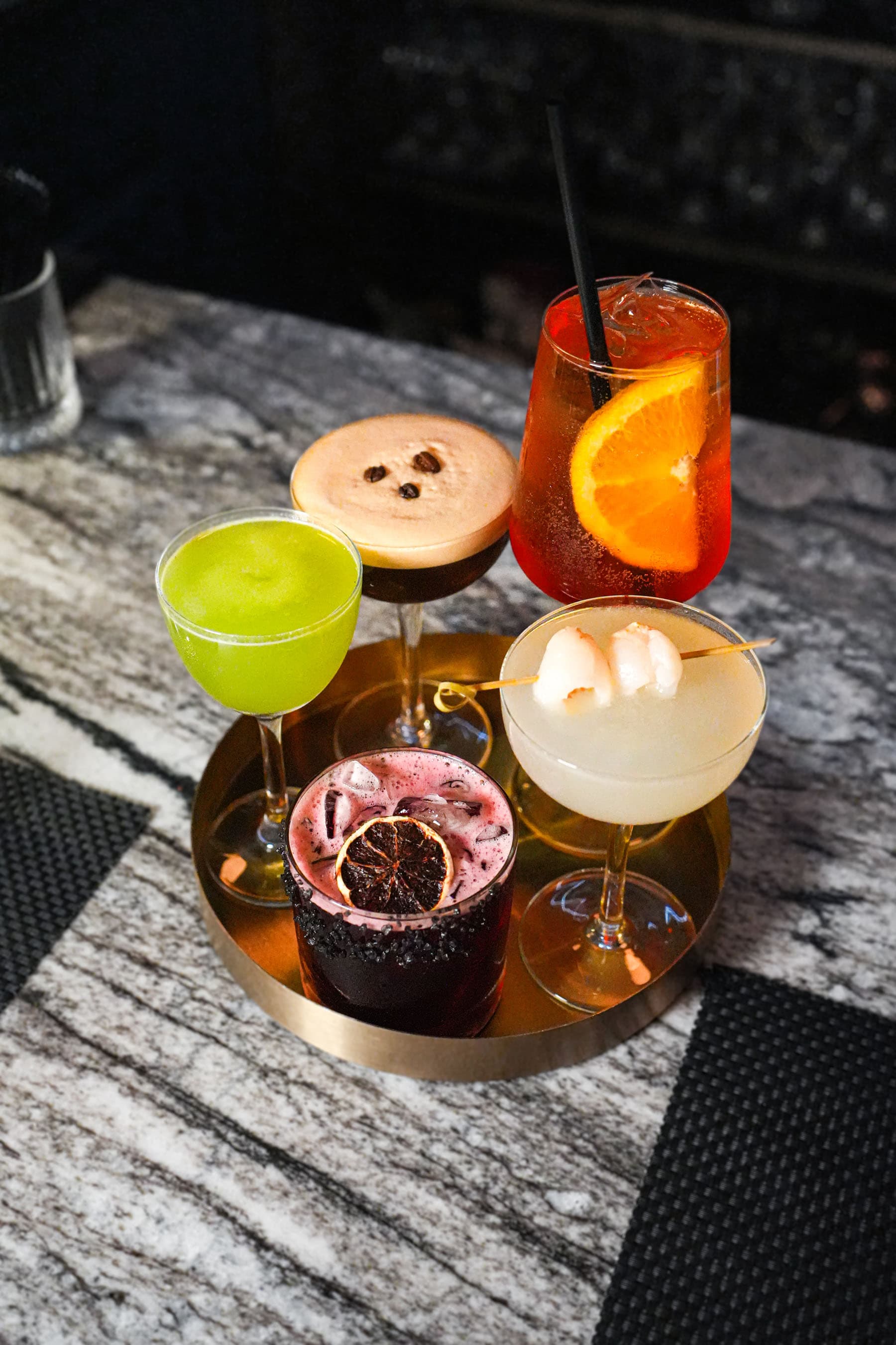 A colorful selection of Siren cocktails arranged at the bar